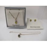 A pair of silver and green amber set earrings and a matching silver pendant, on a fine neckchain;