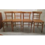 A set of four mid 20thC beech and plywood framed twin bar back chairs, raised on tapered legs