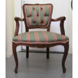 A modern Continental style, stained beech framed, part button upholstered in striped fabric open arm