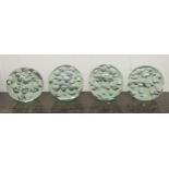 A set of four clear glass door stops with interior bubbled ornament  5"h