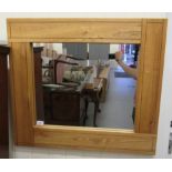 A modern light oak framed mirror with a plain plate  28" x 32"