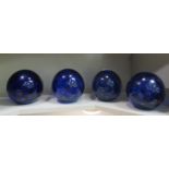 A set of four dark blue glass doorstop with internal bubble decoration  5.5"h