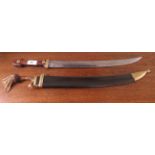 A circa 1912 sword, the curved blade 17"L  bears indistinct marks, on a mahogany handle, in a