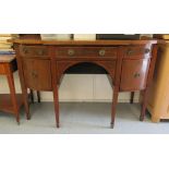 A Regency mahogany breakfront sideboard with two frieze drawers, flanked by two cupboard doors,