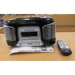 A modern (retro design) Teac digital clock radio/CD player, in black casing with a remote control