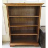 A modern oak open front bookcase with three fixed shelves, on a plinth and bracket feet  43"h  33"h