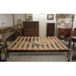 A Victorian style lacquered brass framed double bed, on cast iron supports and a slatted pine