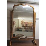 A 1920/30s Queen Anne style walnut framed dressing table mirror, the plate pivoting on square horns,