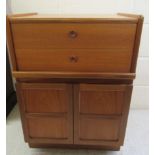 A Nathan teak record cabinet, the hinged lid over two front sliding drawers, enclosing a record deck