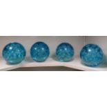 A set of four light blue glass door stops with interior bubbled ornament  5.5"h