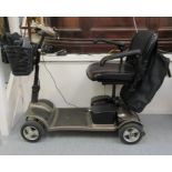 A Zeolite four wheeled electric mobility scooter with a raincover and charger