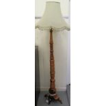 A modern Oriental turned and rough cut hardwood standard lamp, on a crossover plinth  58"h with a
