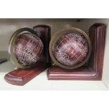 A pair of modern novelty bookends, each fashioned as a printed globe, on a rotating brass mount  5"h