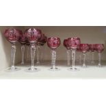 A suite of eighteen clear and cranberry coloured, etched and star-cut (possibly Czech) crystal