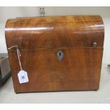 A 19thC table top mahogany tantalus with a curved front hinged lid, enclosing provision for six