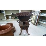 A twin handled cast iron pot barbecue, elevated on splayed feet  20"h