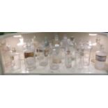 A collection of late 19th/early 20thC clear glass apothecary jars, some with branded labels and