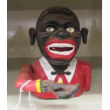 A 20thC painted cast iron novelty money bank, fashioned as a minstrel with an articulated arm