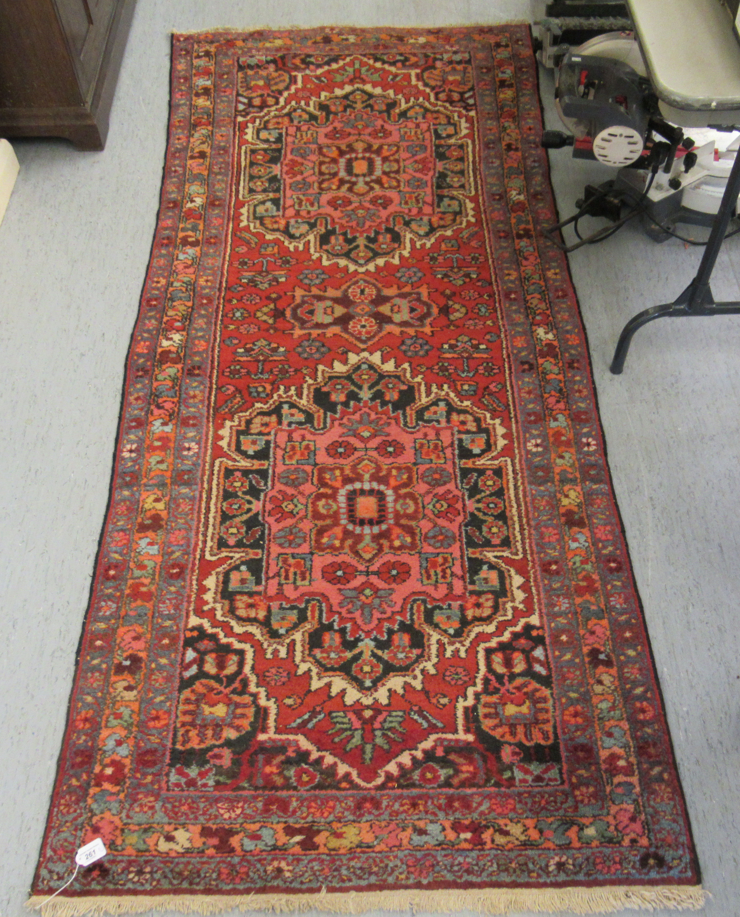 A Persian runner, decorated with stylised floral designs, on a multi-coloured ground  38" x 100"