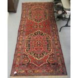 A Persian runner, decorated with stylised floral designs, on a multi-coloured ground  38" x 100"