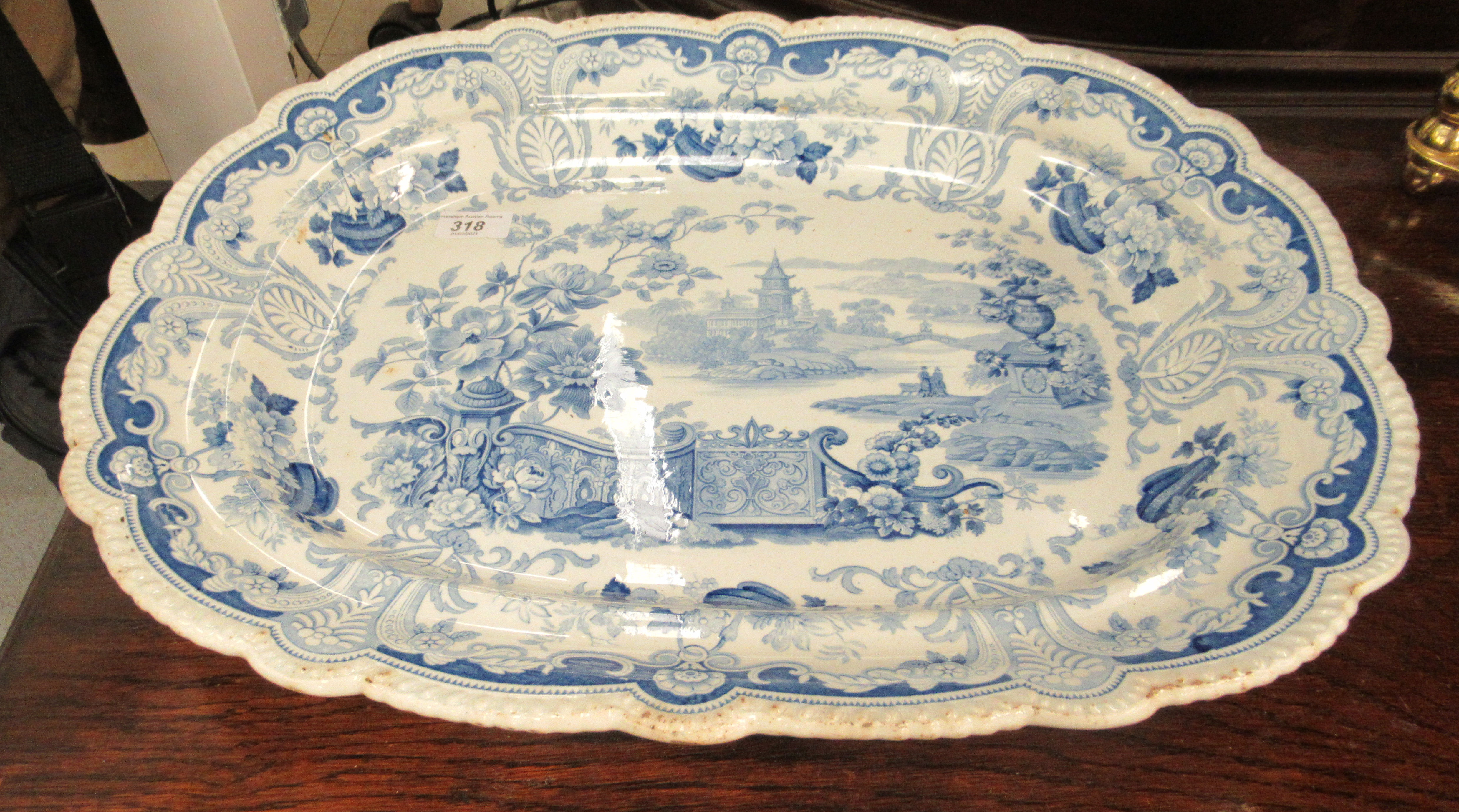A 19thC earthenware meat plate, having a raised wide, wavy edged border, decorated in blue and white - Image 2 of 3