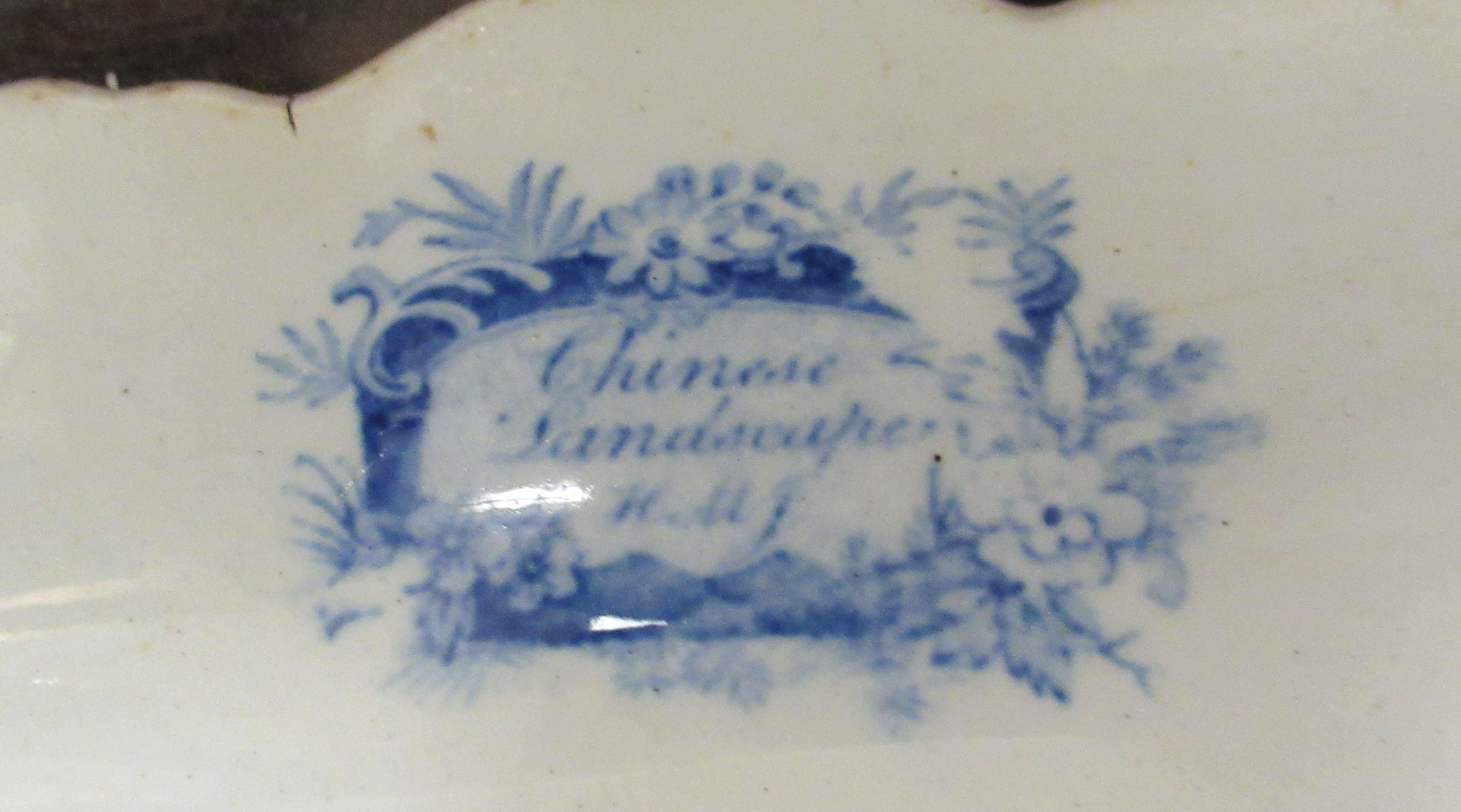 A 19thC earthenware meat plate, having a raised wide, wavy edged border, decorated in blue and white - Image 3 of 3