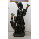 A 20thC Art Nouveau inspired composition lamp, fashioned as a scantily clad maiden and a cherubic