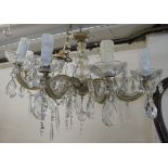 A modern ten branch chandelier with faux wax candle sockets and glass pendants  23"dia