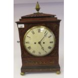 A William IV brass inlaid mahogany cased bracket clock, the fan carved top with a brass pineapple