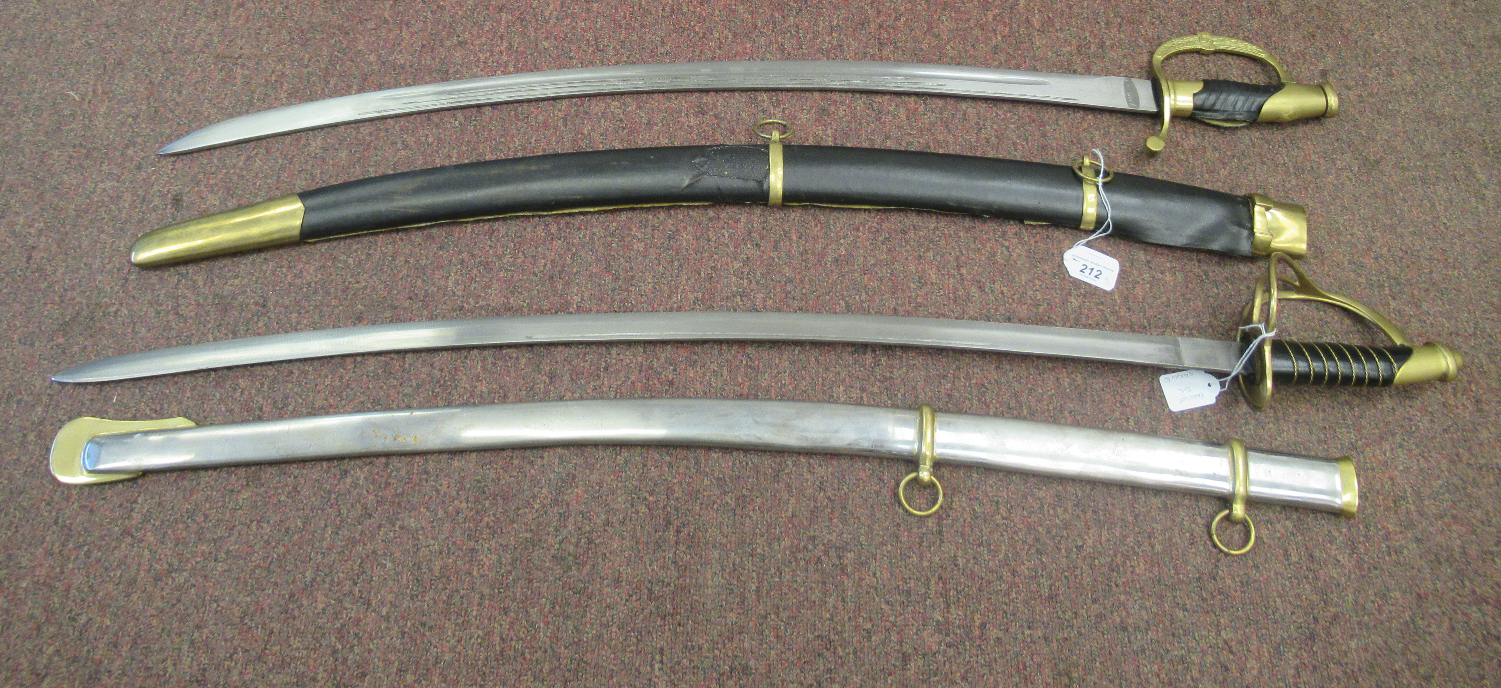 Two similar replica 18thC sabres with fabric covered handles, brass knuckle guards and hilts, the