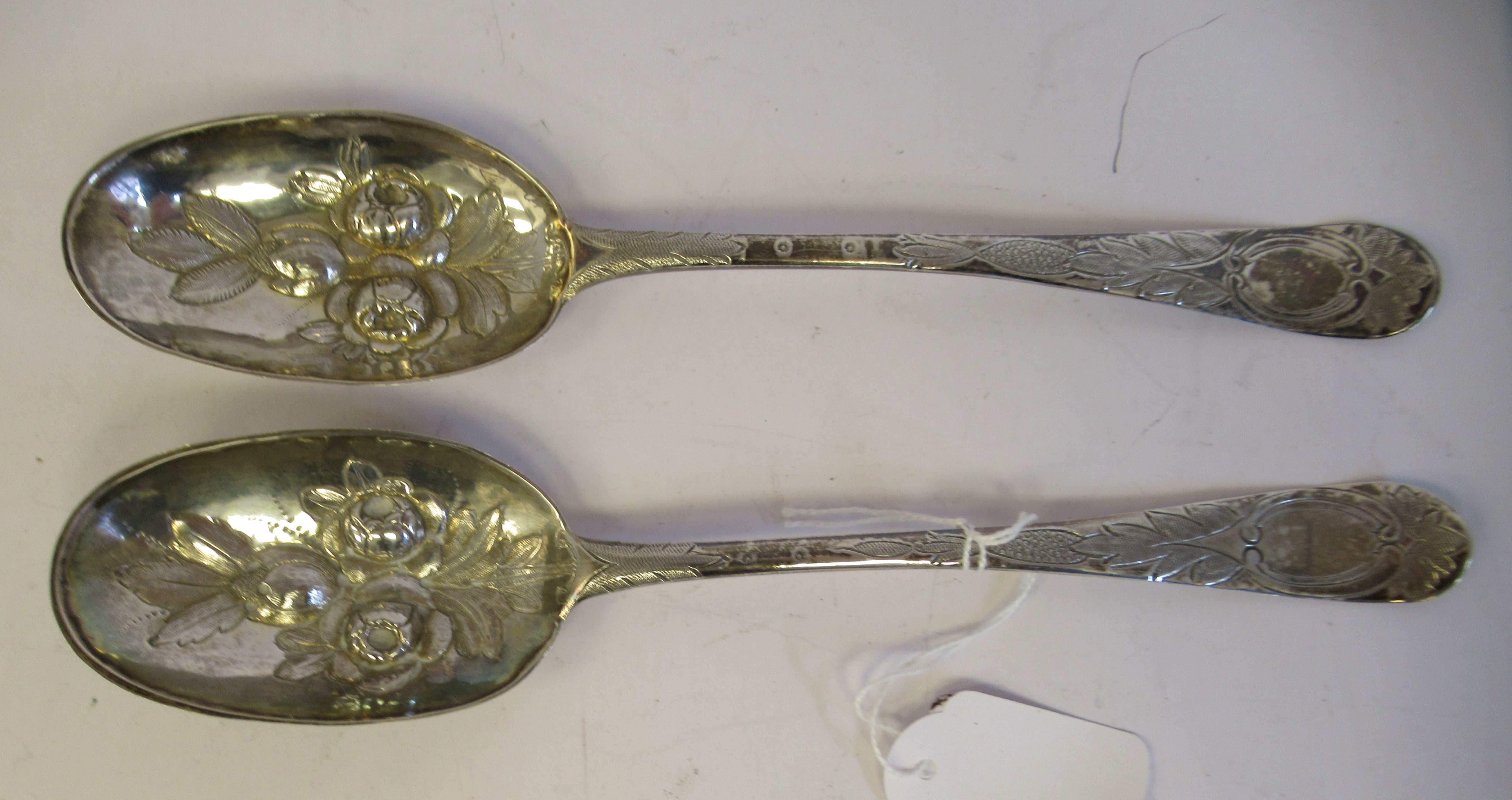 A pair of George III silver Old English pattern berry spoons with impressed, engraved and chased - Image 2 of 4