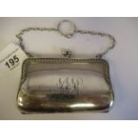A silver purse, fashioned as a lady's handbag with a chain carrying handle and a cast vitruvian