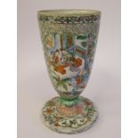 A late 19thC Chinese porcelain trumpet shaped vase, decorated with figures in relief, on a splayed