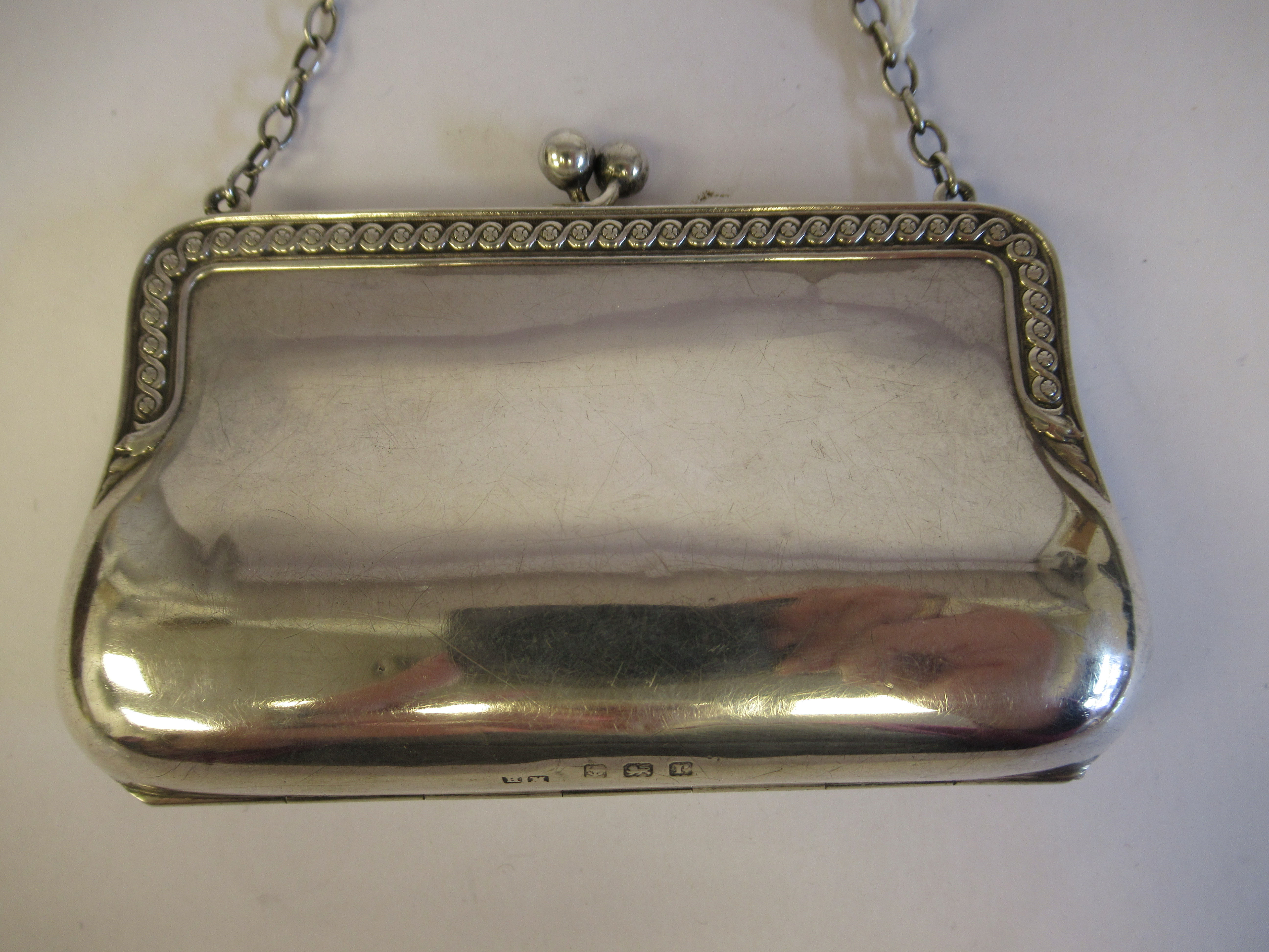 A silver purse, fashioned as a lady's handbag with a chain carrying handle and a cast vitruvian - Image 2 of 5