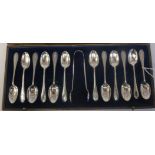 A set of twelve silver teaspoons and a pair of matching sugar tongs with cast bellflower ornament