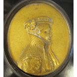 A 19thC cast gilt metal oval, head and shoulders profile portrait miniature, a young man wearing