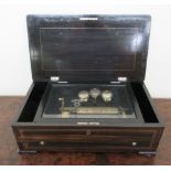 A late 19th/early 20thC Swiss music box, the ebonised and string inlaid rosewood case with a