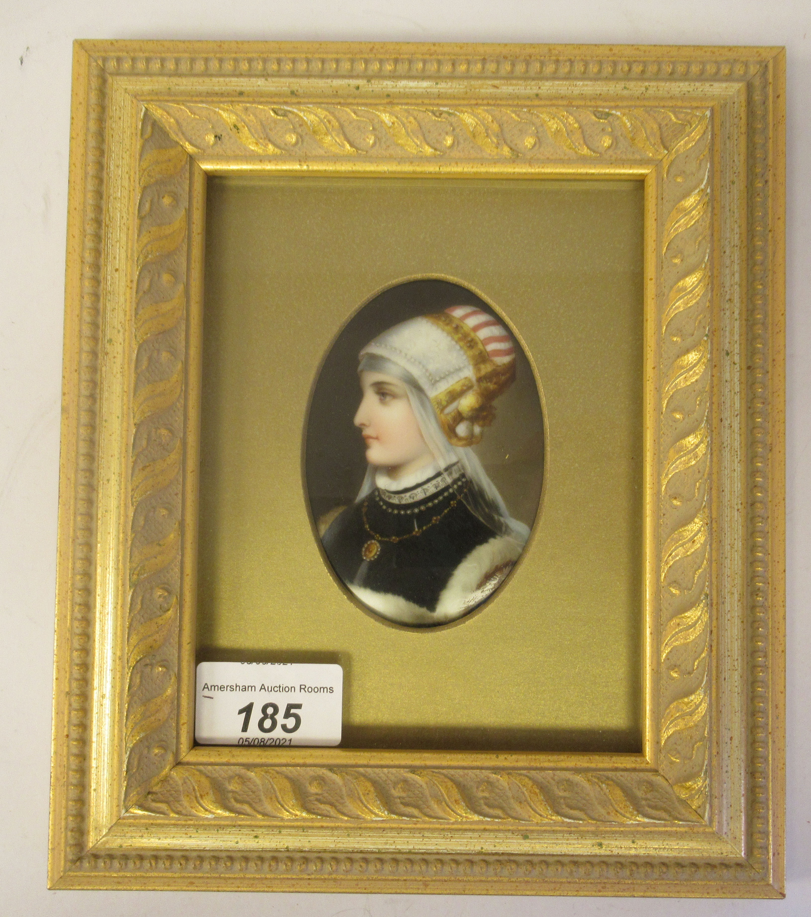 A late 19thC framed painted porcelain oval head and shoulders profile portrait miniature, a young