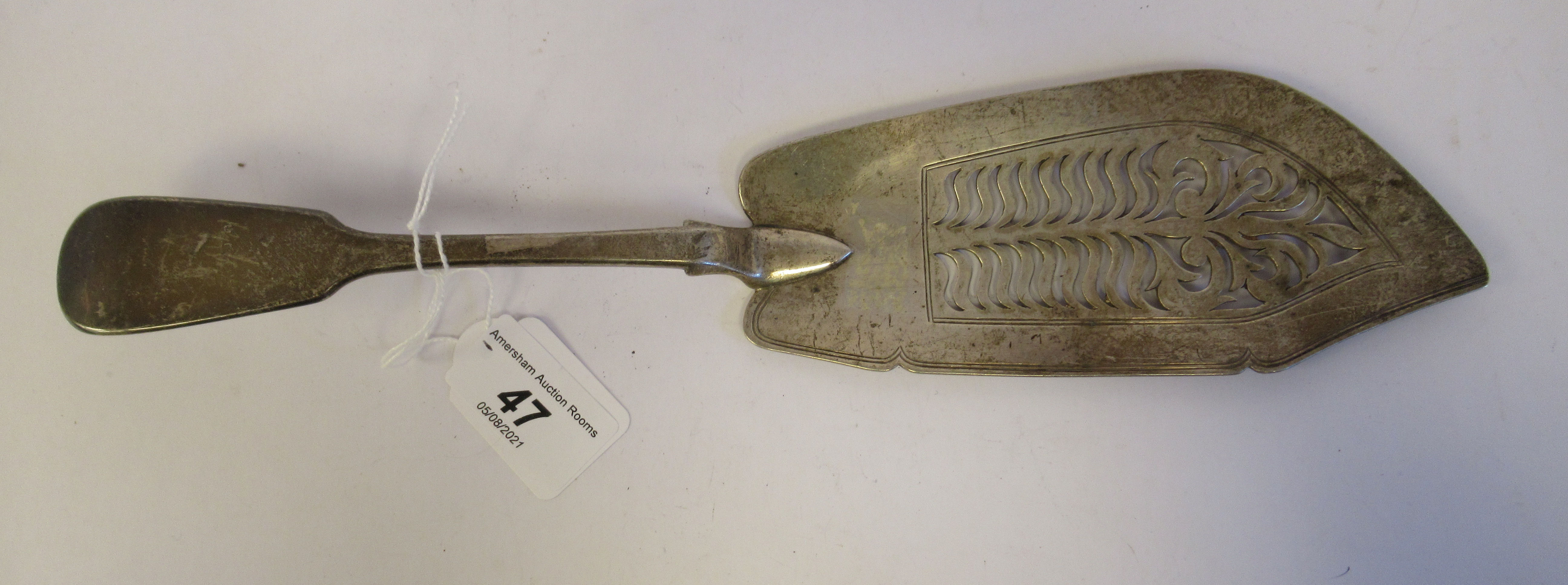 An early Victorian silver fiddle pattern fish slice with a line engraved and decoratively pierced,