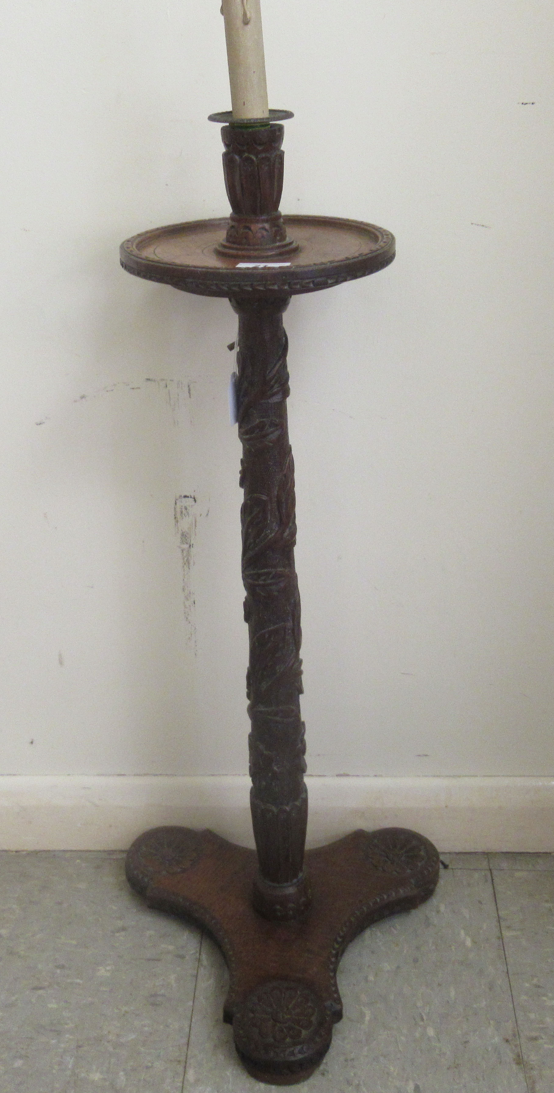 An early 19thC profusely foliate and rosette carved candlestand with a dished top and column, raised