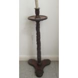 An early 19thC profusely foliate and rosette carved candlestand with a dished top and column, raised