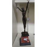 An Art Deco style patinated bronze figure, a female dancer, on a marble and slate effect plinth