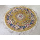 A modern fringed, multi-coloured, floral patterned rug  64"dia