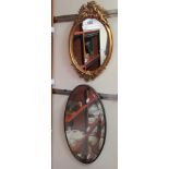 Mirrors: to include an oval example, in a gilded composition frame, surmounted by cherubic