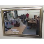 A modern mirror, the bevelled plate set in a silvered frame  24" x 36"