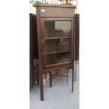 An Edwardian inlaid pine corner cabinet with a single glazed door, raised on chamfered legs  51"h