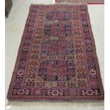 A Persian runner, decorated with elephant foot motifs, on a red and blue ground  69" x 42"