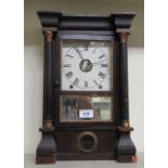 A late 19thC American rosewood and mahogany veneered mantel timepiece; the 8 day movement faced by a