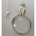 A silver magnifying glass, surmounted by a cat, on a fine neckchain  stamped 925