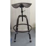 A modern patinated cast metal, tractor design stool with a rotating, height adjustable seat